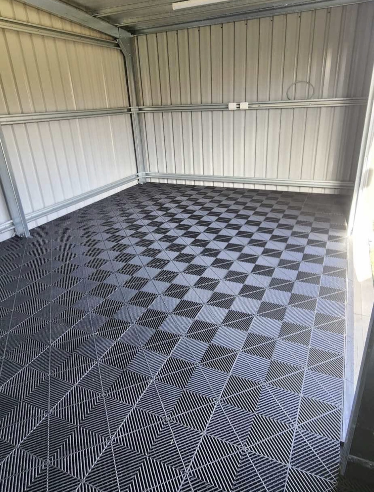 Shed with black and grey checkerboard tile pattern