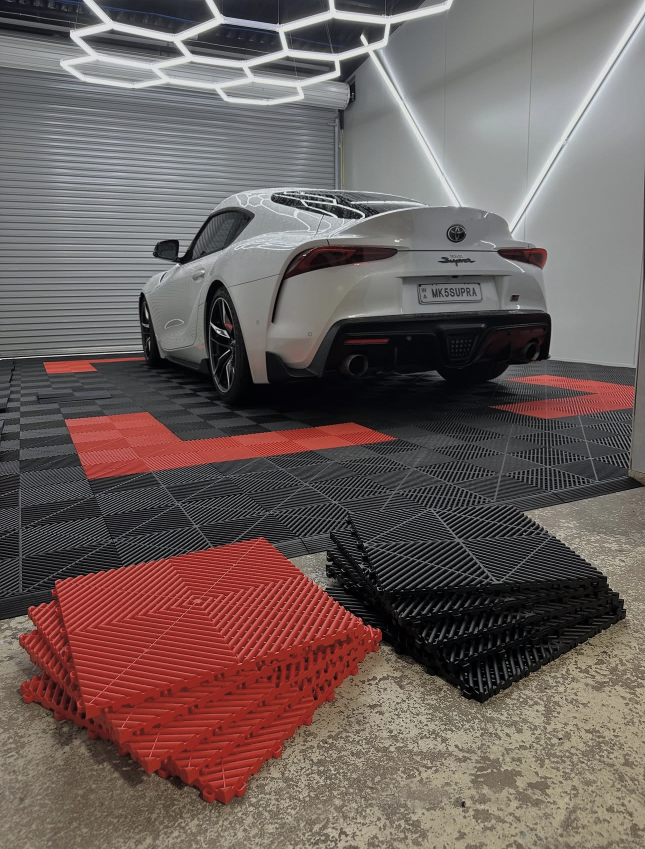 Red and black garage tiles with Toyota Supra