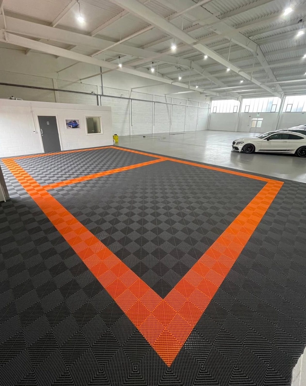 Commercial showroom with orange and charcoal tile layout