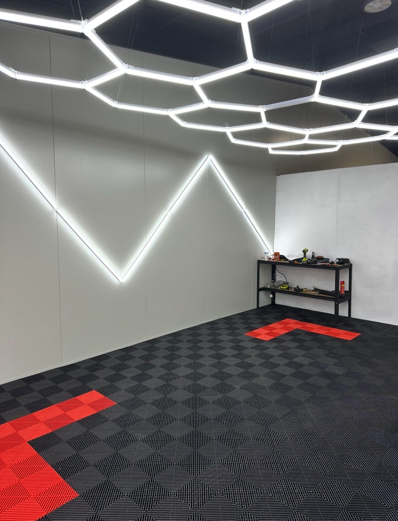 Showroom build with black and red tiles and hex lighting