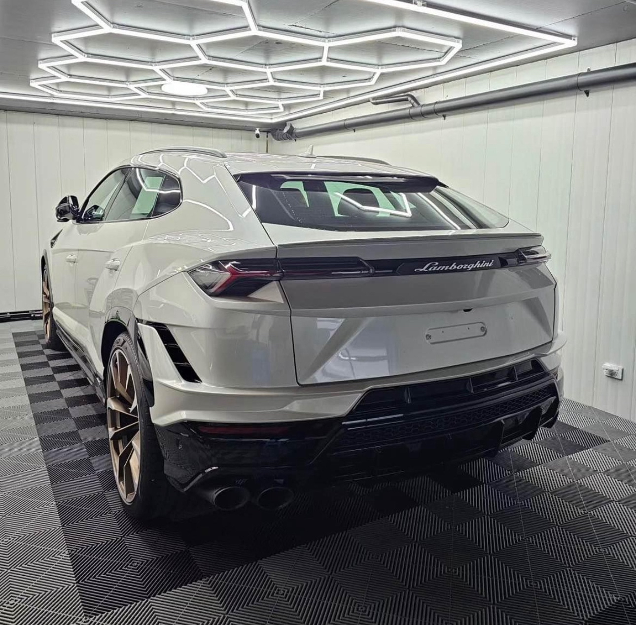 Lamborghini Urus in white garage with hexagon LED lights