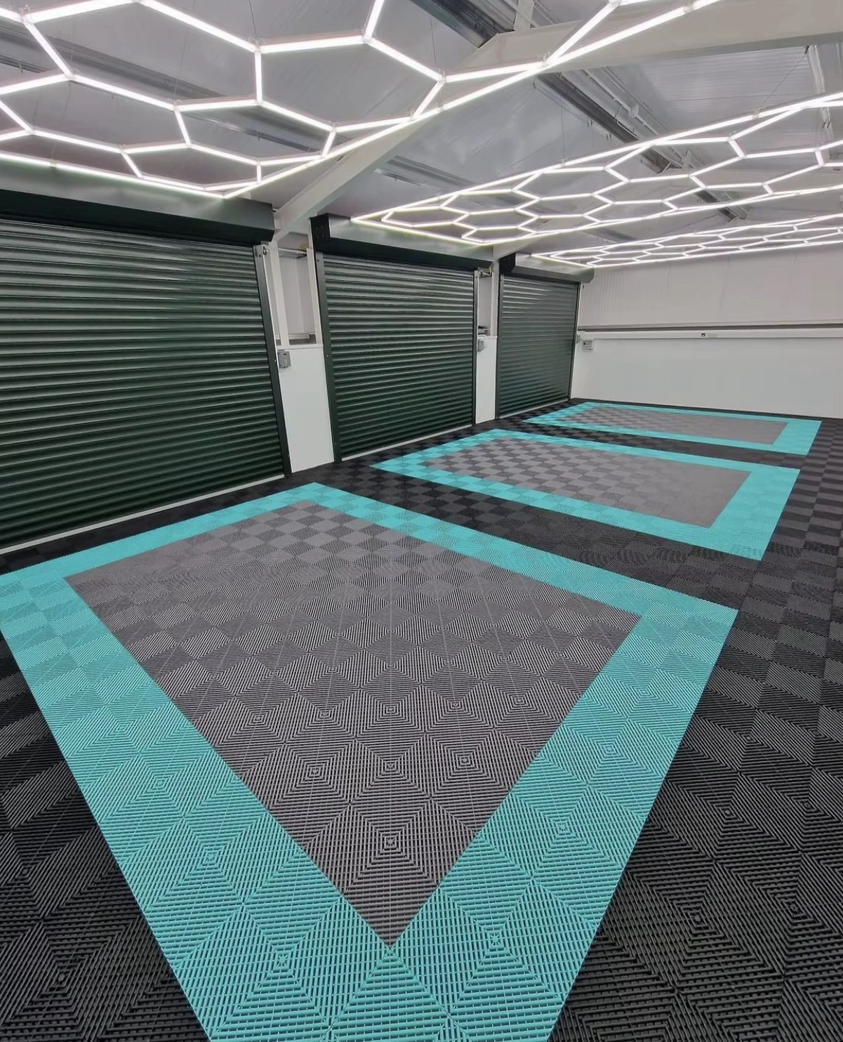 Large commercial workshop with teal and grey tile floor and full hex light ceiling